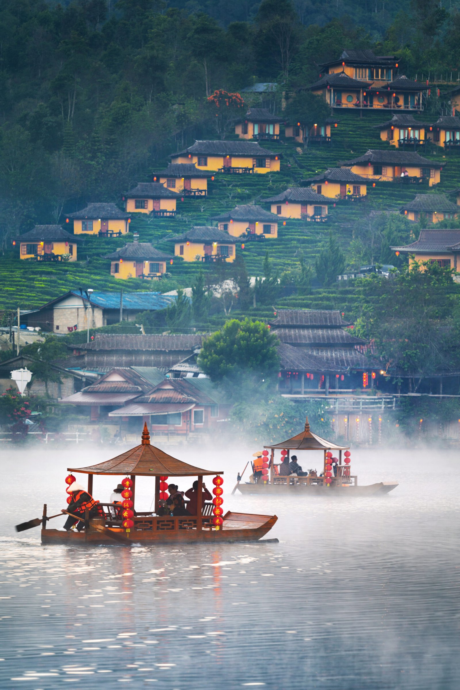 tourist on a boat at ban rak thai village, mae hong son province
